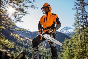 Drewniarz z pilarką Stihl MS 261 C-M w lesie.
